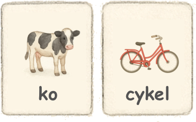 Två ordkort. En med ko, en bild på en ko och ordet ko under, ett kort med en röd cykel och ordet cykel under.